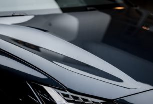 a close up of a black car parked in a garage