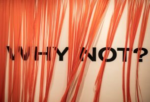 an orange curtain with the words why why on it